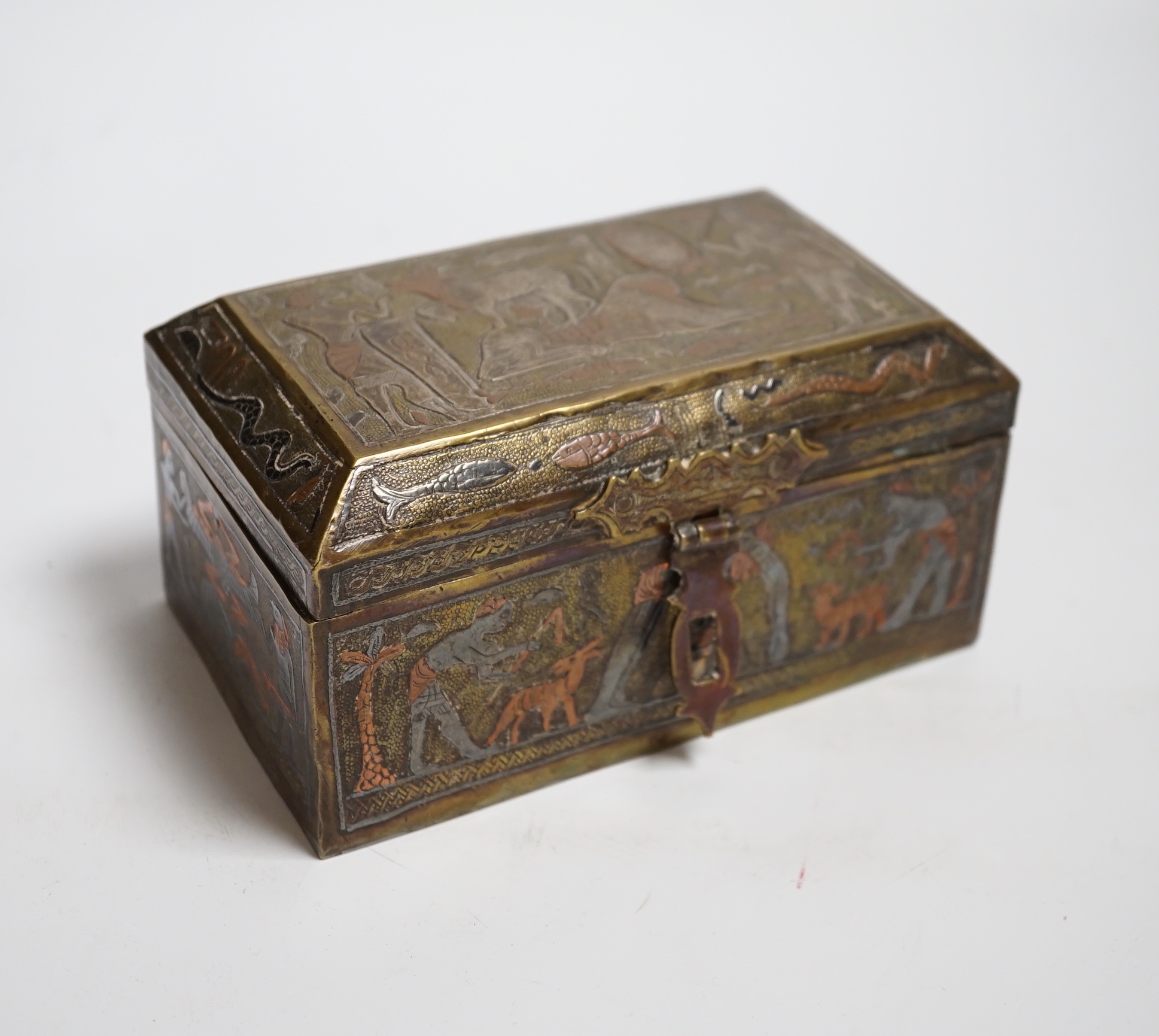 A Cairo ware box, decorated with ancient Egyptian figures, 15.5 cm wide
